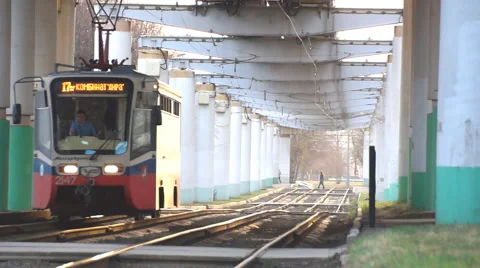 Trams moves under the bridge Stock Footage 68739492