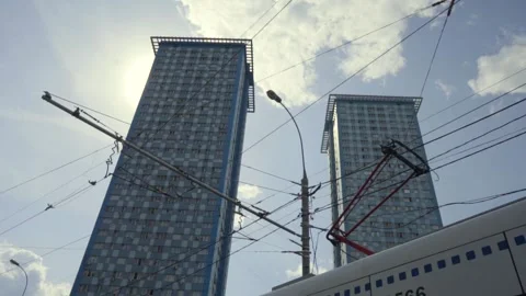 Trams pass in front of two towers in the city Stock Footage 133565392