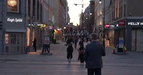 Trams passing revealing a crowded city street during sunset in Oslo city. Stock Footage 245990417