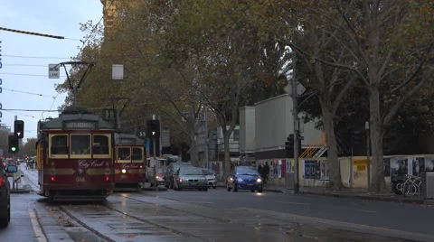 Trams in rain on Melbourne  streets Stock Footage 51363560