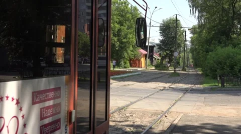 Trams run along a rural-style green track segregation Stock Footage 64638801
