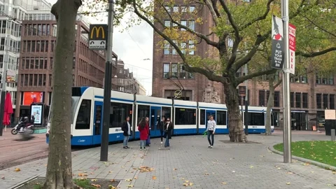Tramway is going next to the park. Amsterdam city public train Stock-Footage 145030159
