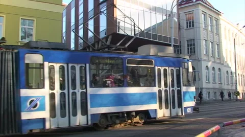 Tramway going right in front of building of English college Tallinn Stock Footage 52079377