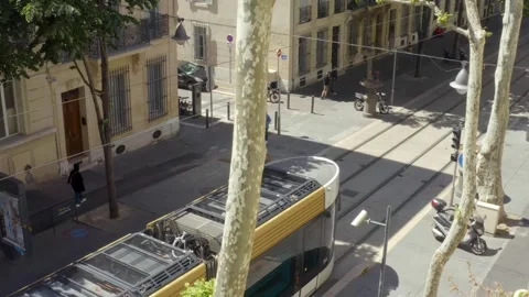 A tramway leaves the station in an authentic district in Marseille, France Stock Footage 246022530