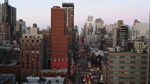 Tramway view of the mean streets of NYC at dusk.  Incredible view only via Stock Footage 103247164