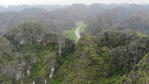 Trang An Mountain with river &amp; rice fields Stock Footage 89861254