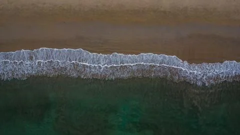 Tranquil aerial view captures the rhythmic dance of foamy white waves Stock Photos