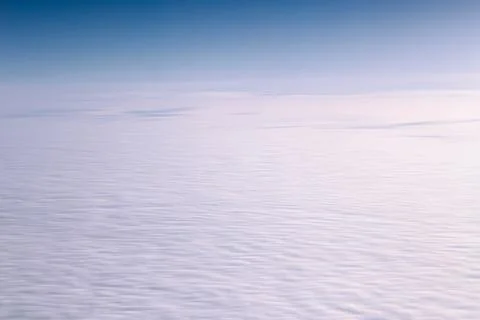 A tranquil aerial view showcasing an endless expanse of fluffy white clouds a Stock Photos