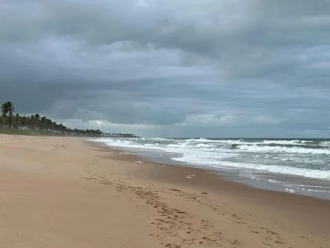 Tranquil and cloudy beach scene Stock Photos