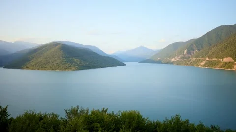 A Tranquil and Idyllic Landscape Featuring Majestic Mountains Surrounded by Stock Footage 318385828