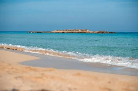 Tranquil Beach with Distant Island Stock Photos