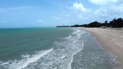 The tranquil beach features gentle waves and glistening salt under a bright summ Stock Footage 315752486