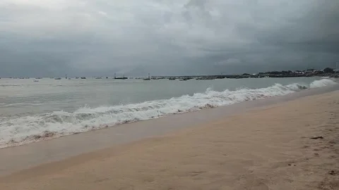 Tranquil Beach with Gentle Waves Under Cloudy Sky Stock Footage 318211168