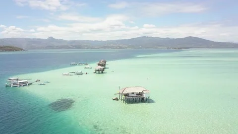 Tranquil beach resort in the ocean with pristine turqouise blue clear water. Stock Footage 132545155