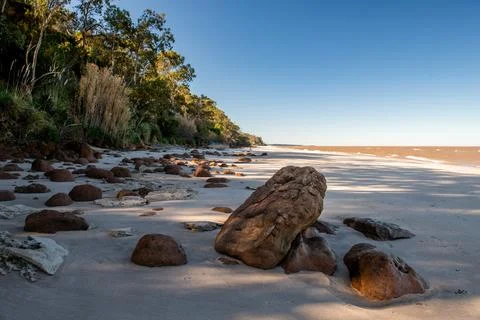 Tranquil Beach, Rocks, Greenery, Clear Sky in Kiyu, Uruguay Stock Photos