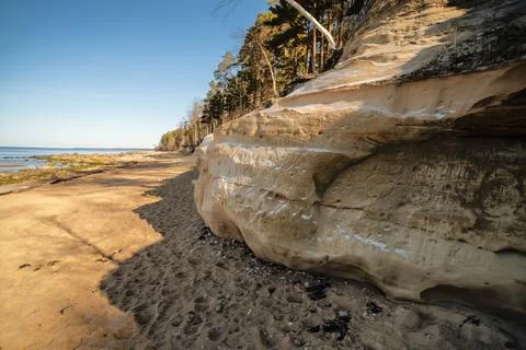 A Tranquil Beach Scene with Eroded Rocks and Trees, Veczemju cliffs, Latvia 스톡 사진