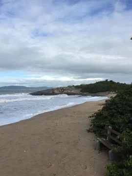 Tranquil beach scene with footprints Stock Photos