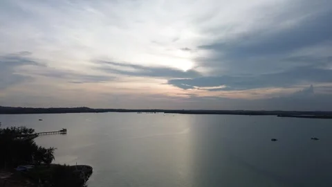 Tranquil Beach Scene at Sunset with Reflecting Water and Beach in the Distance Video stock 325194153