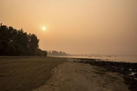 Tranquil Beach Sunset With Calm Waves and Peaceful Atmosphere Stock Photos