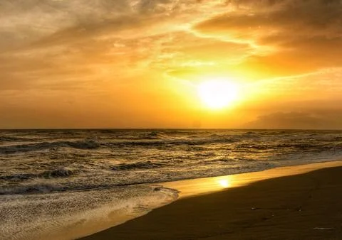 Tranquil Beach Sunset with Gentle Ocean Waves Stock Photos