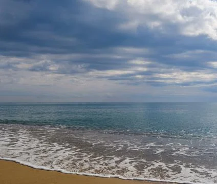 Tranquil Beach Sunset with Gentle Ocean Waves Stock Photos