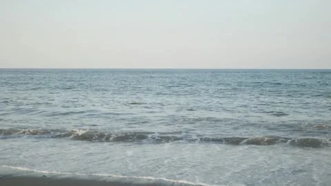 Tranquil Beach Vibes Small Gentle Waves Caressing the Shoreline Stock Footage 254932581