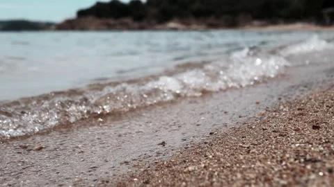 The tranquil beach waves gently caressing the soft sandy shore create a perfect Stock Footage 312525980