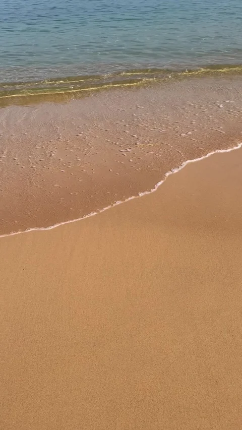 Tranquil Beach Waves on Golden Sands Stock Footage 257581758