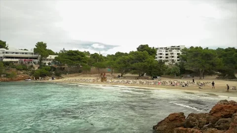 Tranquil Beachfront with Crystal Clear Water and Resort View Stock-Footage 300903215