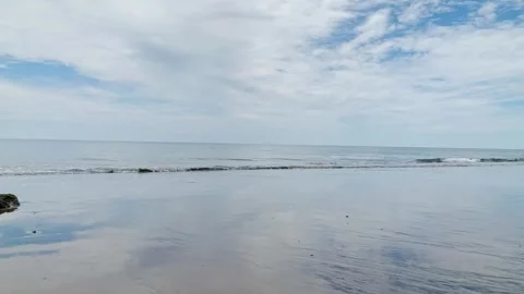 Tranquil Beachscape with a Clear Sky Stock Footage 295447363