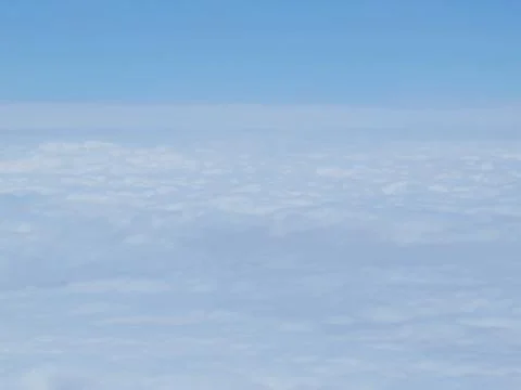 Tranquil Beautiful View From Plane Window at Blue Sky over White Clouds Stock Photos
