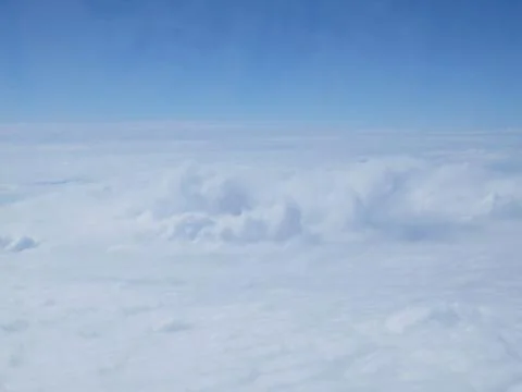 Tranquil Beautiful View From Plane Window at Blue Sky over White Clouds Stock Photos