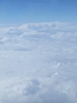 Tranquil Beautiful View From Plane Window at Blue Sky over White Clouds Stock Photos