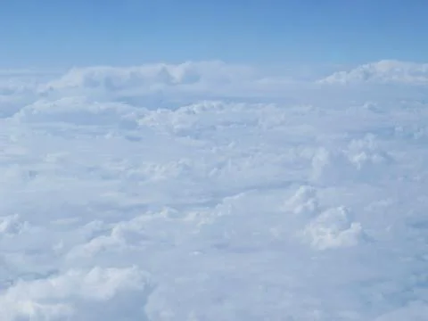 Tranquil Beautiful View From Plane Window at Blue Sky over White Clouds Stock Photos