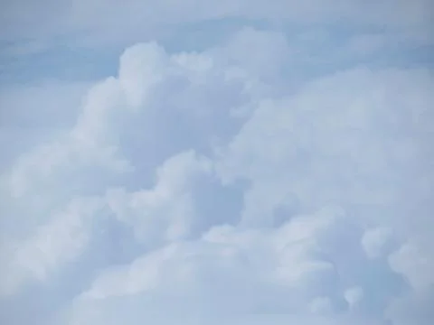 Tranquil Beautiful View From Plane Window at Blue Sky over White Clouds Stock Photos