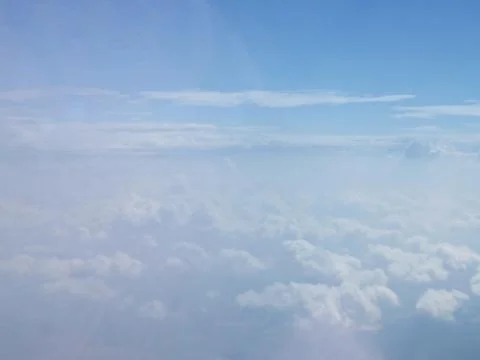 Tranquil Beautiful View From Plane Window at Blue Sky over White Clouds Stock Photos