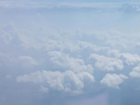 Tranquil Beautiful View From Plane Window at Blue Sky over White Clouds Stock Photos