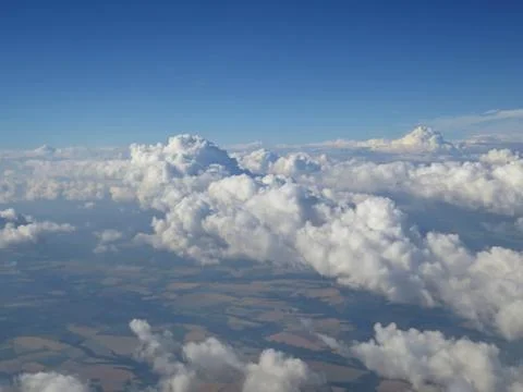 Tranquil Beautiful View From Plane Window at Blue Sky over White Clouds Stock Photos