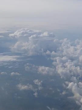 Tranquil Beautiful View From Plane Window at Blue Sky over White Clouds Stock Photos