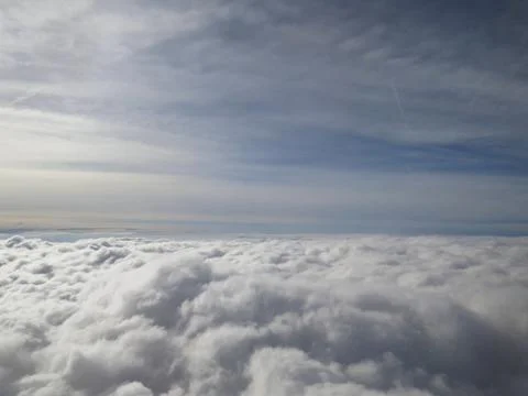 Tranquil Beautiful View From Plane Window at Blue Sky over White Clouds Stock Photos
