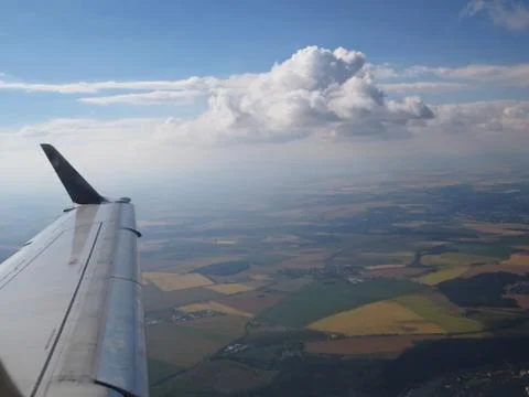 Tranquil Beautiful View From Plane Window at Blue Sky over White Clouds with  Stock Photos