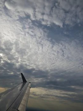 Tranquil Beautiful View From Plane Window at Blue Sky over White Clouds with  Stock Photos