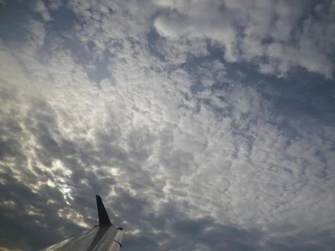 Tranquil Beautiful View From Plane Window at Blue Sky over White Clouds with  Stock Photos