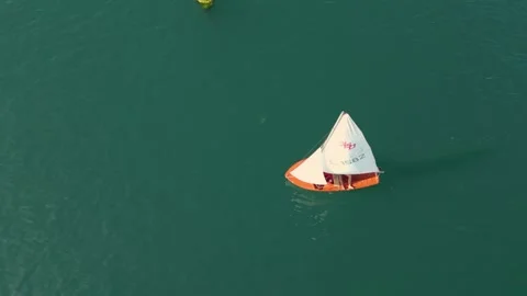 Tranquil Blue Ocean With Sailboat During Summer. Aerial Topdown Stock Footage 248962261