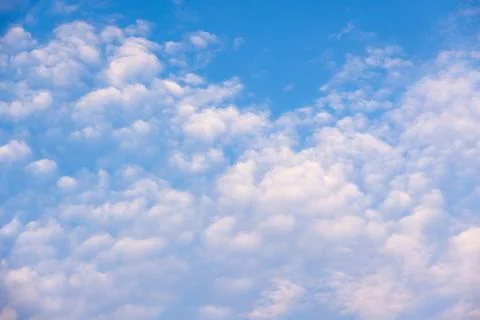 A tranquil blue sky filled with fluffy cumulus clouds Stock Photos