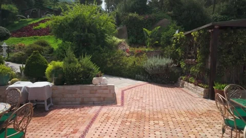 Tranquil Cafe Patio with Lush Green Garden at Cap Spartel in Tangier, Morocco Stock Footage 341365137