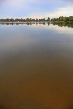 Tranquil Calm Waters and Mirror Reflection at Srah Srang Ancient Royal Reservoir Stock Photos