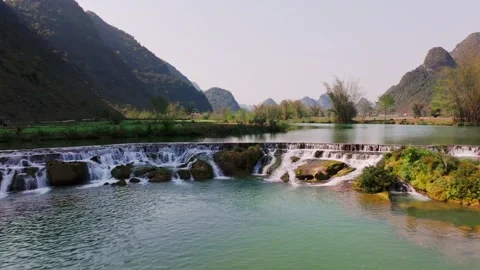 Tranquil Cascade and Serene River in Phong Nam Valley, Cao Bang Stock Footage 280382383