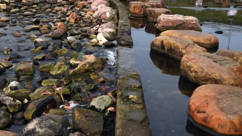 Tranquil city park river stream with stepping stones and flowing water over conc Stock-Footage 333264277