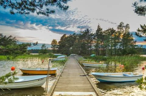 Tranquil cloud landscape above the forest side in Sweden with wooden pathway  Stock Photos